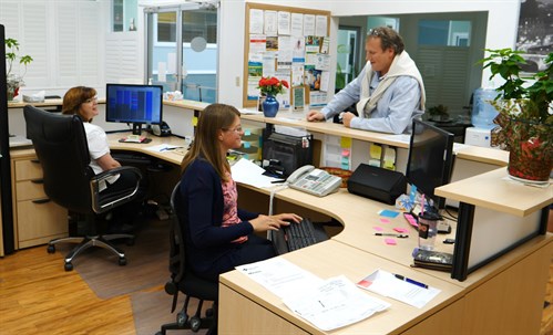 Dr. John Gillett chats with his medical office assistants.