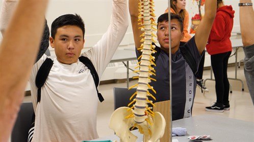 Brandon Fontaine (left) learns about physiotherapy.