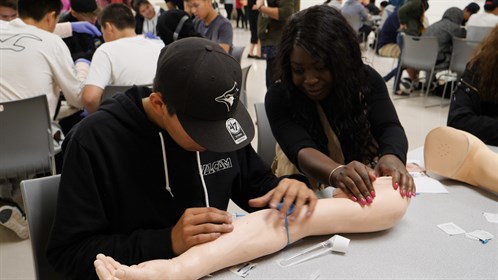A student practises an IV start at the skills day in Fort Chipewyan for students of Athabasca Delta Community School