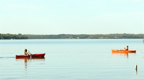 Two canoeists enjoy a beautiful afternoon on Moose Lake, near Bonnyville.
