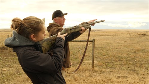 Fred Furlong coaches students on how to line up the sights.