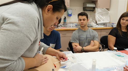 Lori Kemble teaches wound care to students from Calgary at an RhPAP Skills Day Event