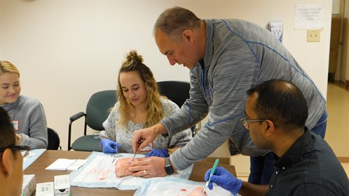 Mark Simons teaches suturing to healthcare students from Calgary at an RhPAP Skills Day in Milk River