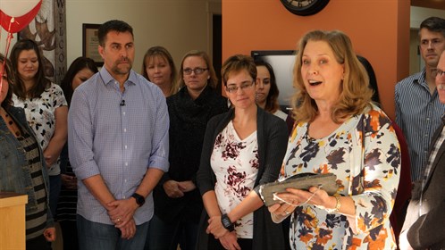 Drs. Rob & Vesta Michelle Warren are about to receive an award from Dr. Joan Horton, Alberta College of Family Physicians, at the Moose & Squirrel Medical Clinic in Sundre, AB.