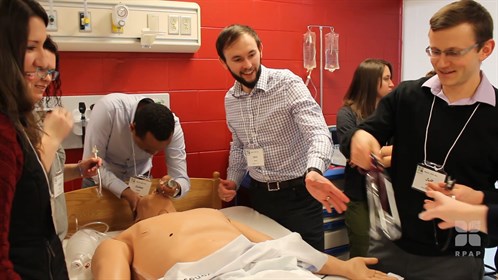 Post secondary students work on the medi-man at a skills event in Bassano