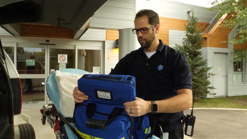 Advanced care paramedic Vincent Dazé checks his supplies on his ambulance outside the Nunnee Health Centre in Fort Chipewyan.