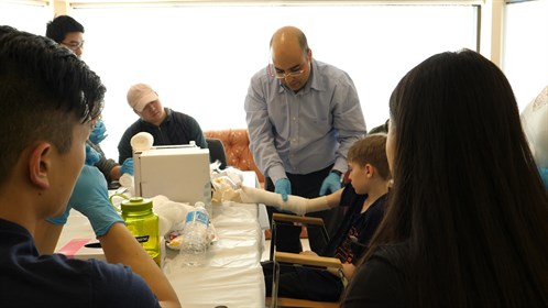 Dr. Elewadly, one of two physicians in Swan Hills, shows students how to cast.  He came to Swan Hills about a year and a half ago from Dubai.