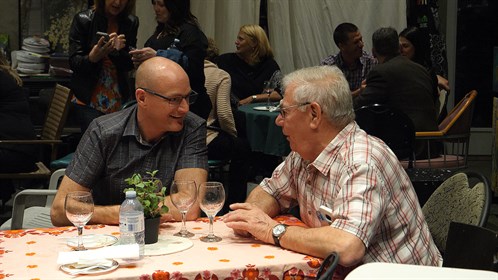 Scott Korbett networking with Al Campbell during the opening night social at the Red Roof Studio, near Duchess, AB.