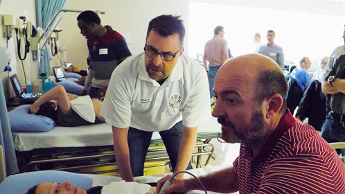 Dr. Rob Warren from Sundre instructs Dr. Ziets Hendriks (R) from Brooks.