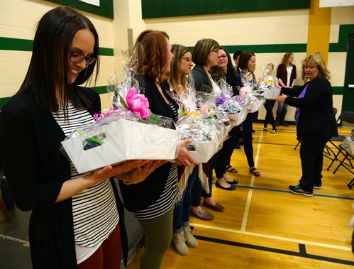 Barb Sjoquist hands out gift baskets to the alumni instructors.