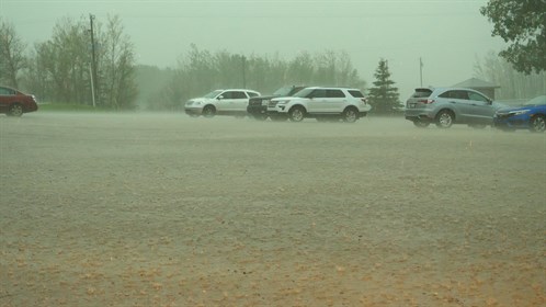 Heavy rain falls in the parking lot at the Grand Centre Golf Course in Cold Lake.