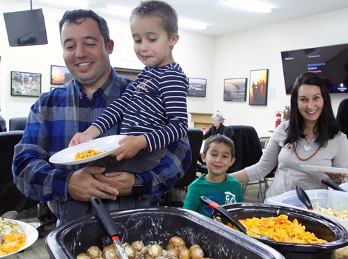 Dr. Willem De Flamingh and his wife Melody and their sons Juan and Willem help themselves to dinner at the appreciation event.