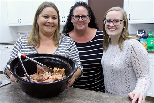 Working together to build community: Provost community members Jeannette Knox, Kari Schultz and Taylor Schultz volunteered to prepare the dinner for the appreciation event at the Provost Fire Hall.